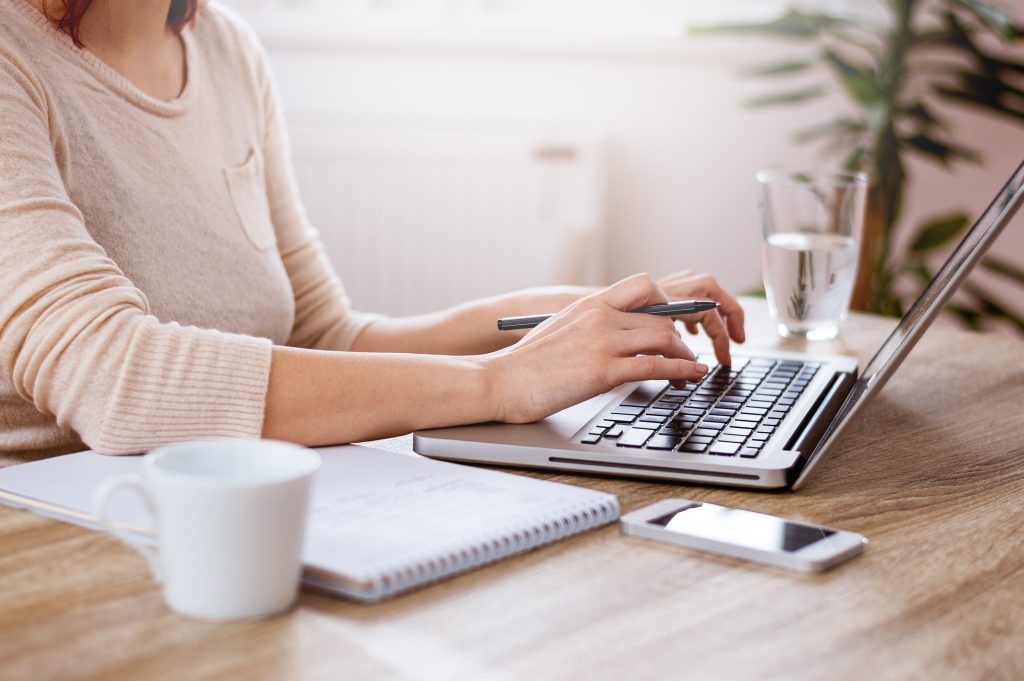 woman typing on her laptop