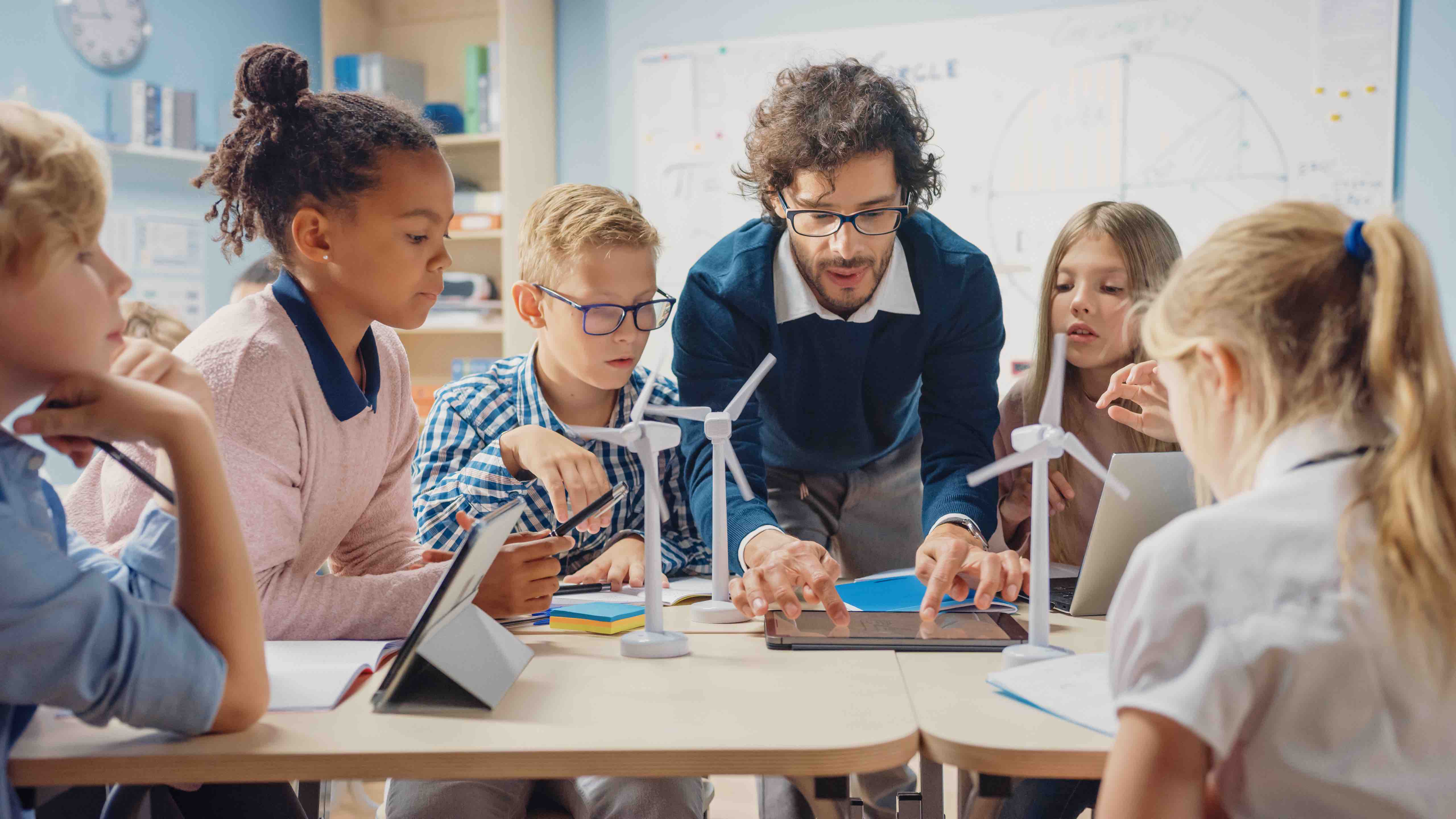 male teacher teaching students