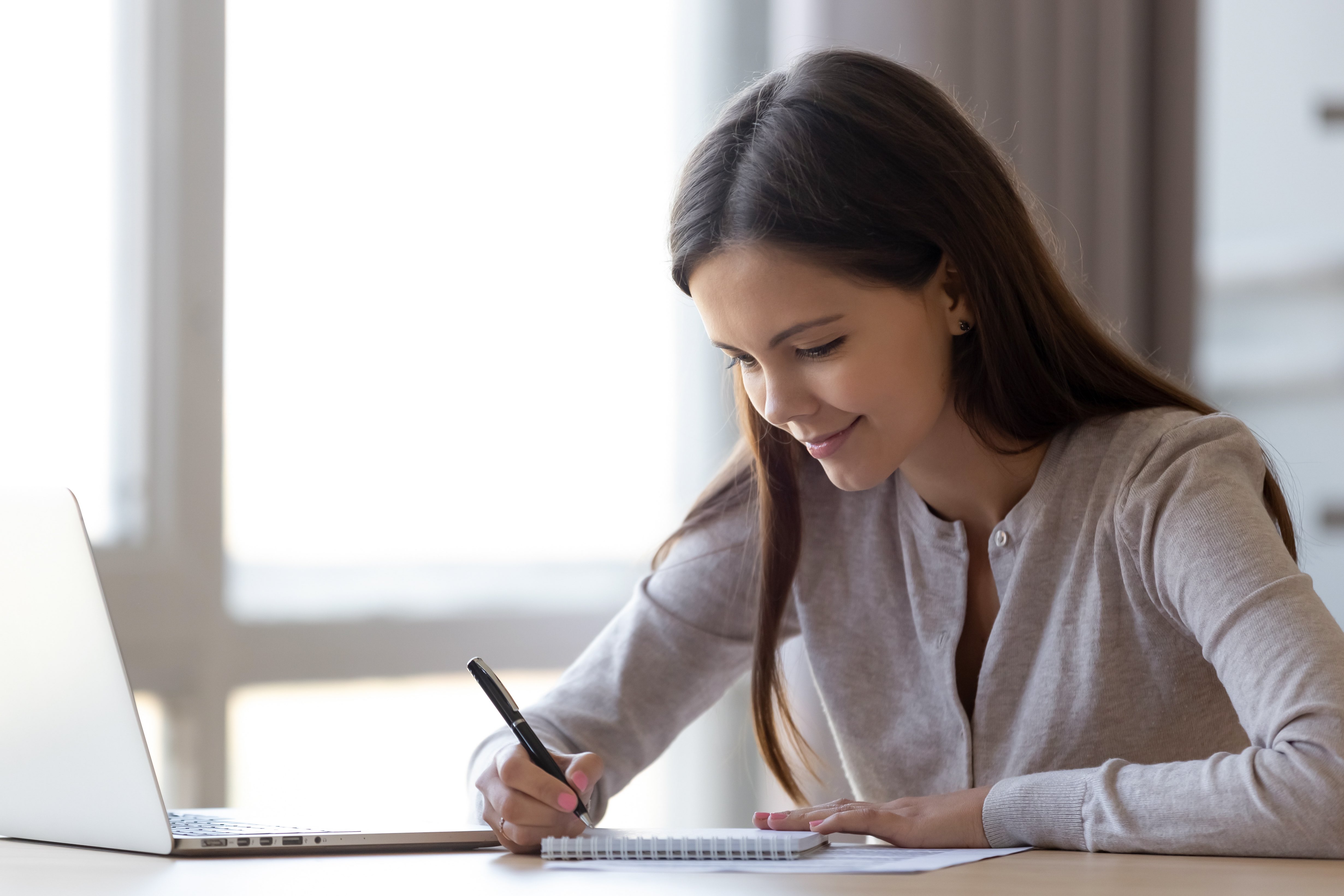 college girl writing on notebook