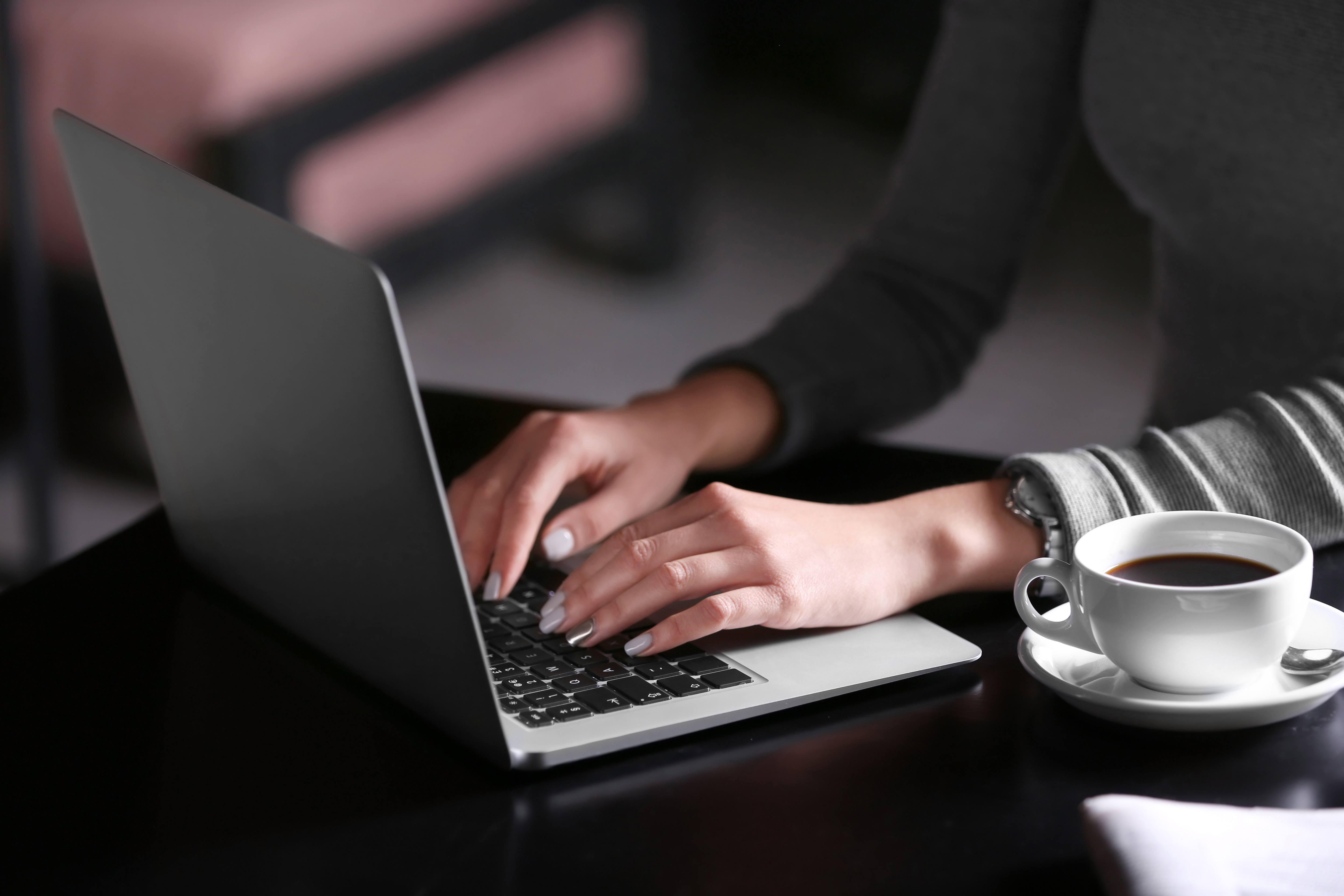 Woman working with laptop in cafe