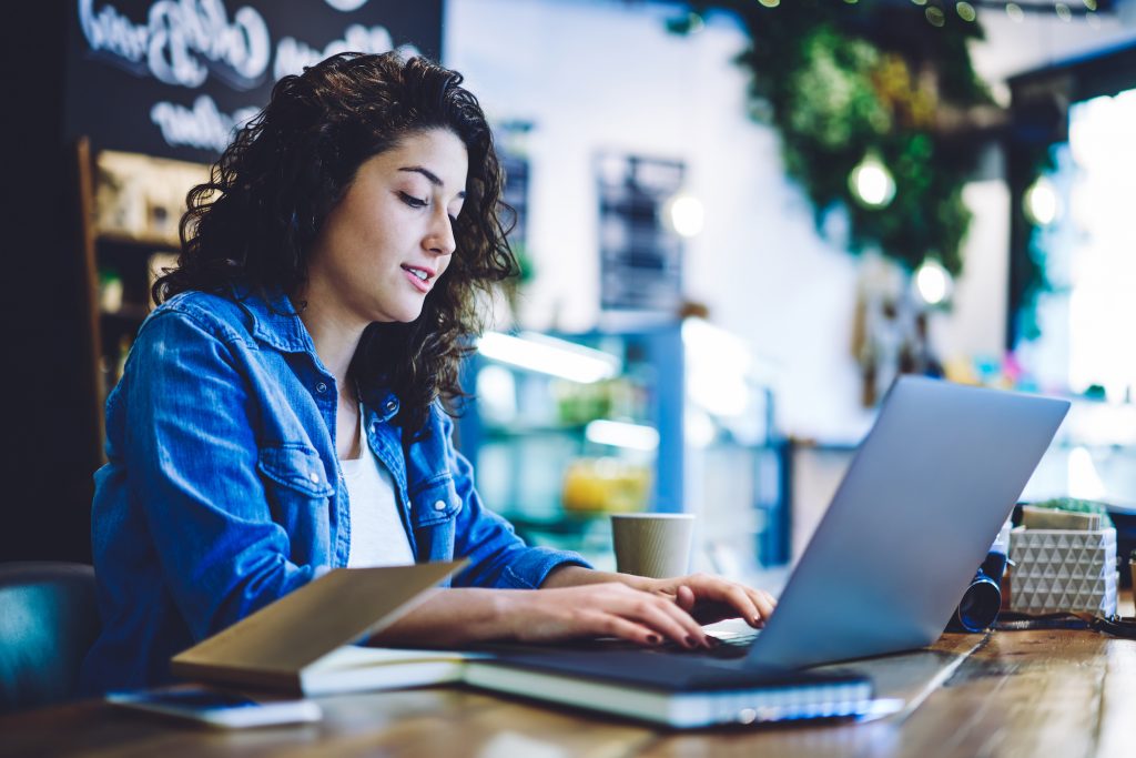 woman using laptop doing online content