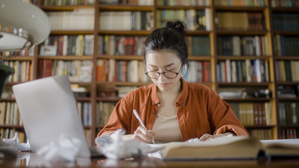 Young woman in the middle of creative process, brainstorming ideas for an article