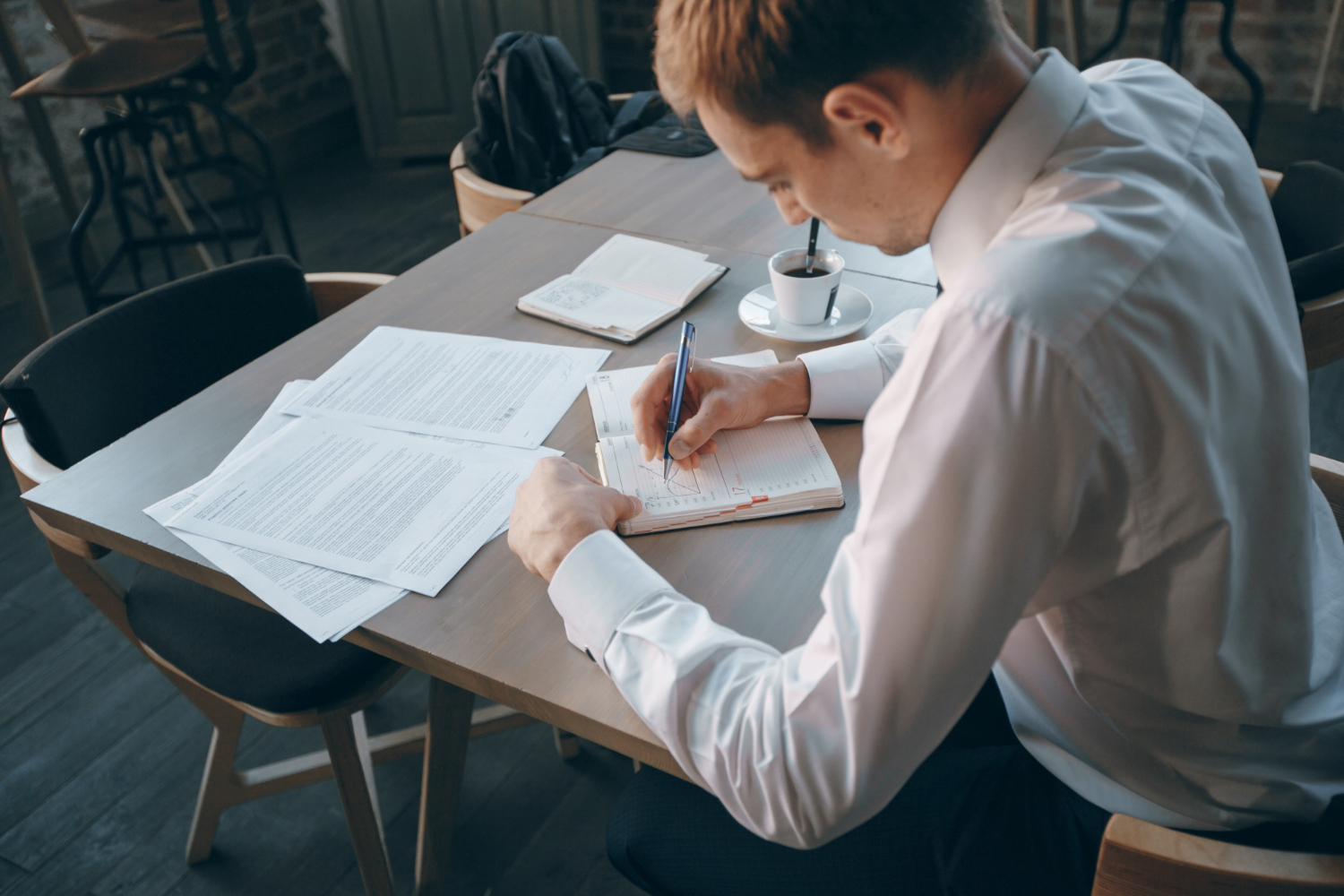 man writing in a notebook